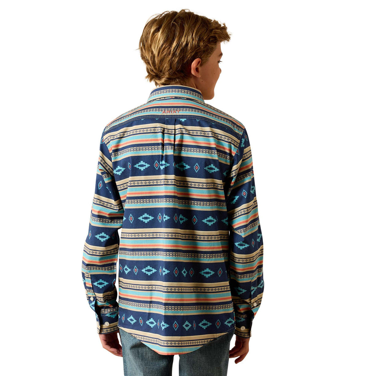 A boy viewed from the back wearing a long-sleeve button-up shirt with a colorful geometric tribal pattern in navy, blue, orange, and beige, paired with blue jeans against a white background.