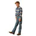 A young boy modeling a long-sleeve western shirt with a blue, beige, and orange geometric pattern, paired with blue jeans and brown boots, on a white background.