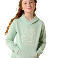 A young woman with freckles and long wavy light brown hair wearing a sage green hoodie with a white horseshoe graphic and the text 'Make your own luck' on the front, set against a plain white background.