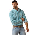 A man wearing a light blue long-sleeve button-down shirt with a small white geometric pattern, paired with light blue jeans and a brown belt, photographed against a solid white background.