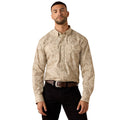 A man wearing a beige and brown paisley patterned long-sleeve western shirt with black pants, standing against a plain white background.