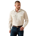 Man wearing a beige button-up shirt and blue jeans on a white background