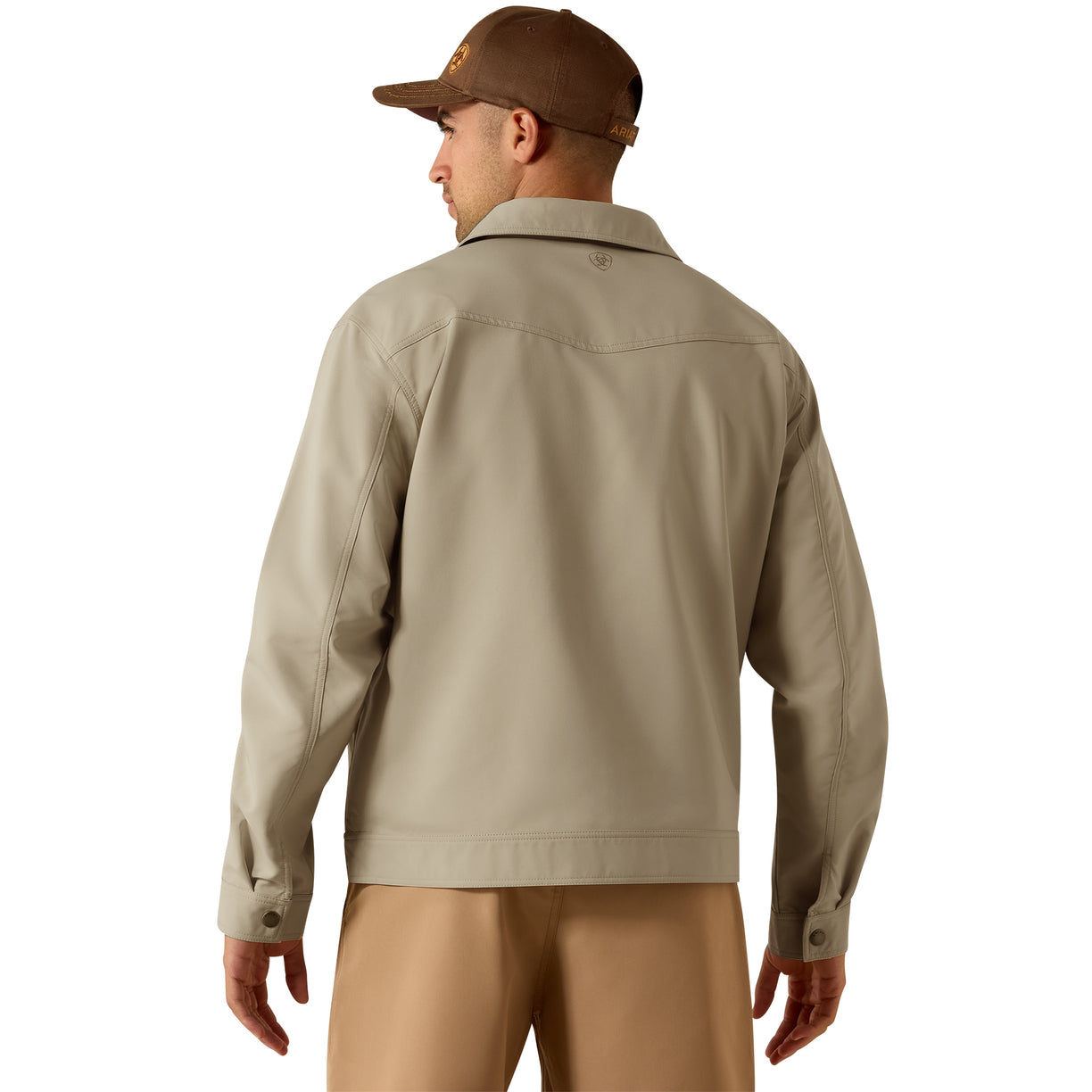 Man wearing a beige jacket and pants with a brown cap on a white background