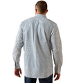 Man wearing a long-sleeve patterned shirt on a white background