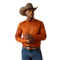 Man wearing an orange shirt, blue jeans, and a brown cowboy hat on a white background