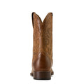 Brown cowboy boot with intricate embossing on a white background