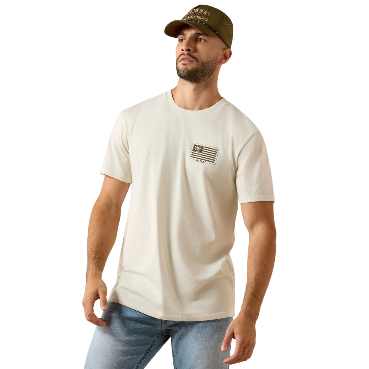 Man wearing a white t-shirt with a logo and a cap on a beige background