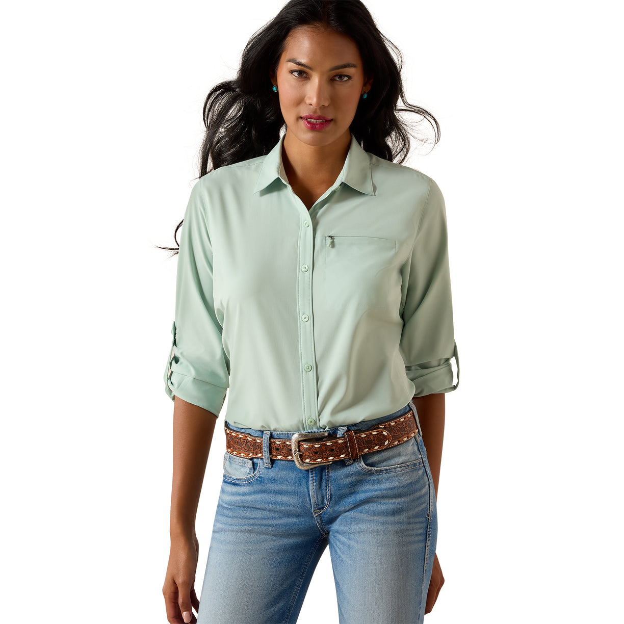 Woman wearing a light green shirt and blue jeans on a white background