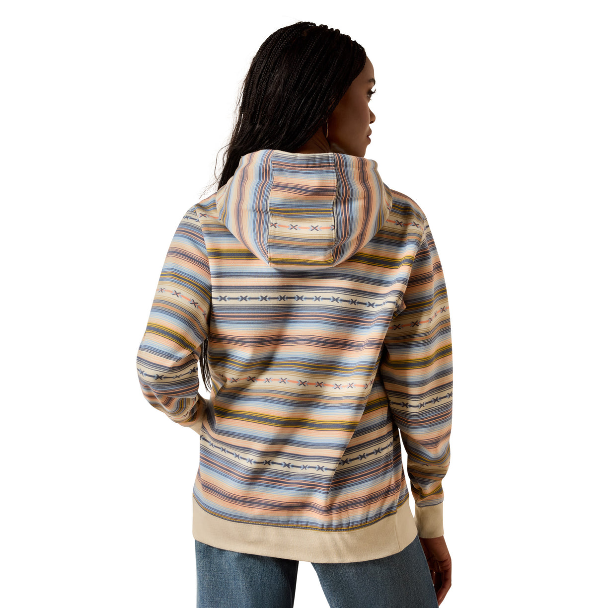 A woman shown from the back wearing a hooded sweatshirt with horizontal multicolor stripes in beige, blue, orange, and brown, paired with blue jeans against a plain white background.