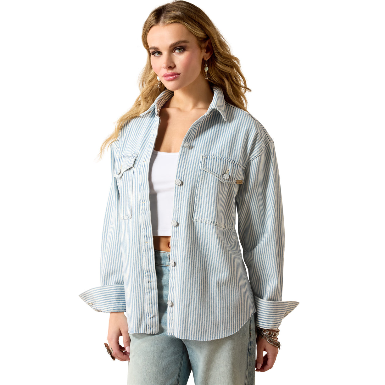 Woman wearing a light blue striped shirt over a white top on a white background
