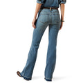 Woman wearing a denim shirt and jeans with a beige hat on a white background