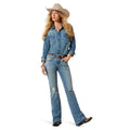 Woman wearing a blue denim shirt and jeans with a cowboy hat on a white background