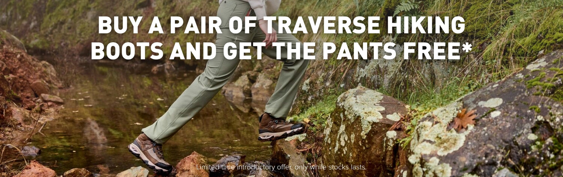 Hiker crossing a creek wearing Ariat traverse hiking gear - boots and pants.