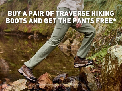 Hiker crossing a creek wearing Ariat traverse hiking gear - boots and pants.