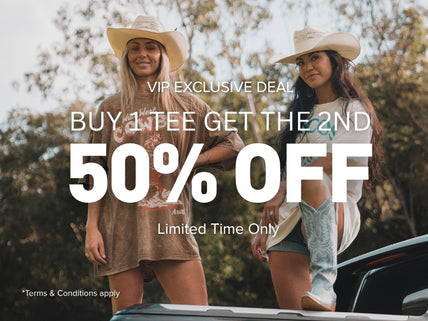 Two women wearing Ariat graphic tees outdoors
