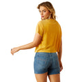 Woman wearing a yellow t-shirt and denim shorts on a white background