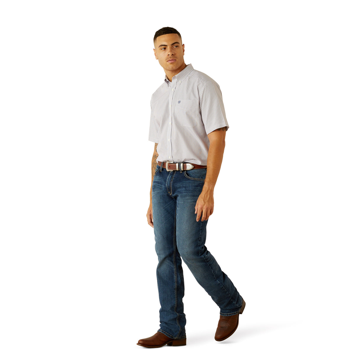 Man wearing a light gray short-sleeve shirt and blue jeans on a white background