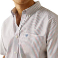 Close-up of a striped shirt with a visible brand logo on a white background