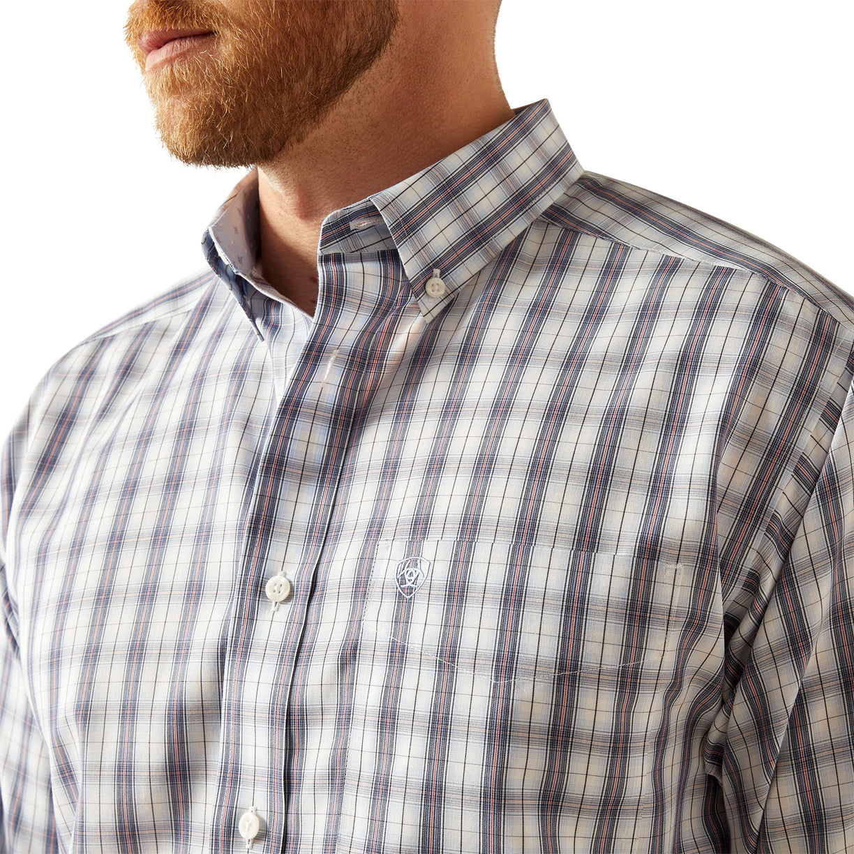 Close-up of a man wearing a plaid shirt with a visible brand logo.
