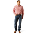 Man wearing a pink shirt and blue jeans on a white background
