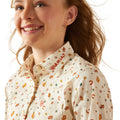 Person wearing a patterned shirt with visible branding on a white background