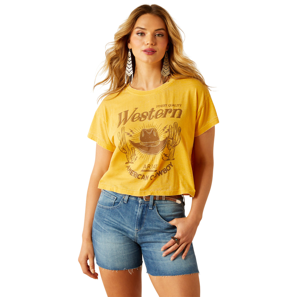 Woman wearing a yellow 'Western' t-shirt and denim shorts on a white background