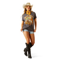 Woman wearing a 'Wild West' themed t-shirt, cowboy hat, and boots on a white background