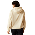 Person wearing a beige hoodie on a white background