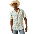 Man wearing a tropical patterned shirt and straw hat on a white background