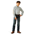 Person wearing a patterned shirt, jeans, and brown shoes on a white background