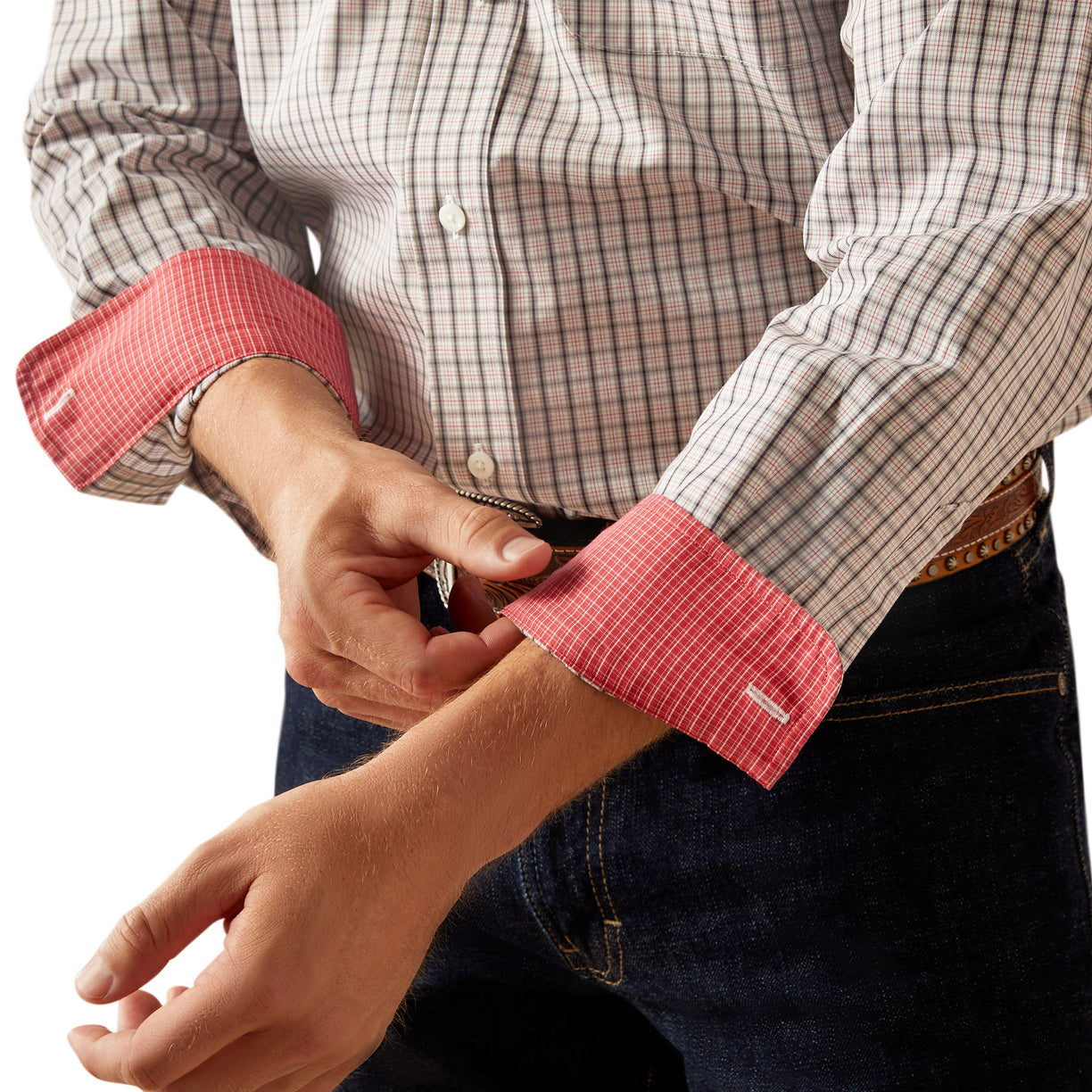 Close-up of a person wearing a checkered shirt with red cuffs on a white background