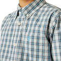 Close-up of a plaid shirt with a brand logo on a white background