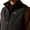 Black vest with a brand logo worn by a person on a white background