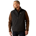 Man wearing a black and brown Ariat jacket on a white background