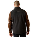 Person wearing a black and brown Ariat jacket on a white background