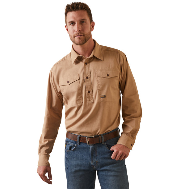 A man wearing a long sleeve khaki workshirt with half button placket, chest pockets, and a collar.